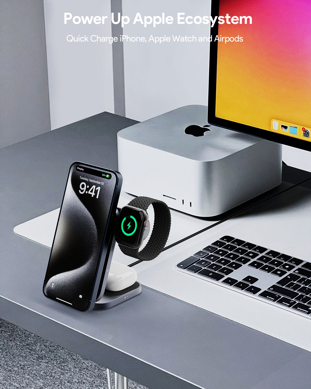 AUKEY MagFusion Z Pro 3-in-1 wireless charger station charging iPhone, Apple Watch, and AirPods on a desk next to a computer