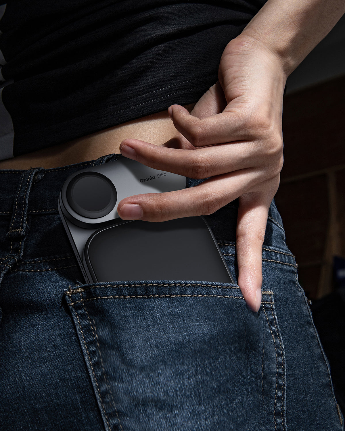 AUKEY MagFusion Z Pro Qi2.2 25W 3-in-1 foldable wireless charger being placed in a jeans pocket