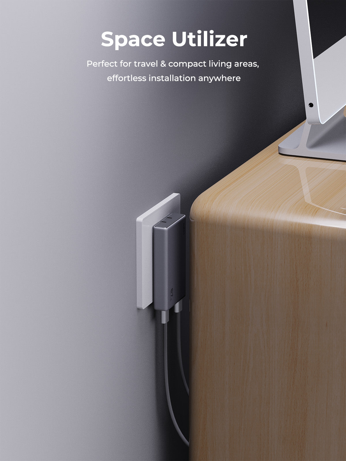 AUKEY Comet Slim 67W PD Wall Charger with GaN technology plugged into wall socket next to desk