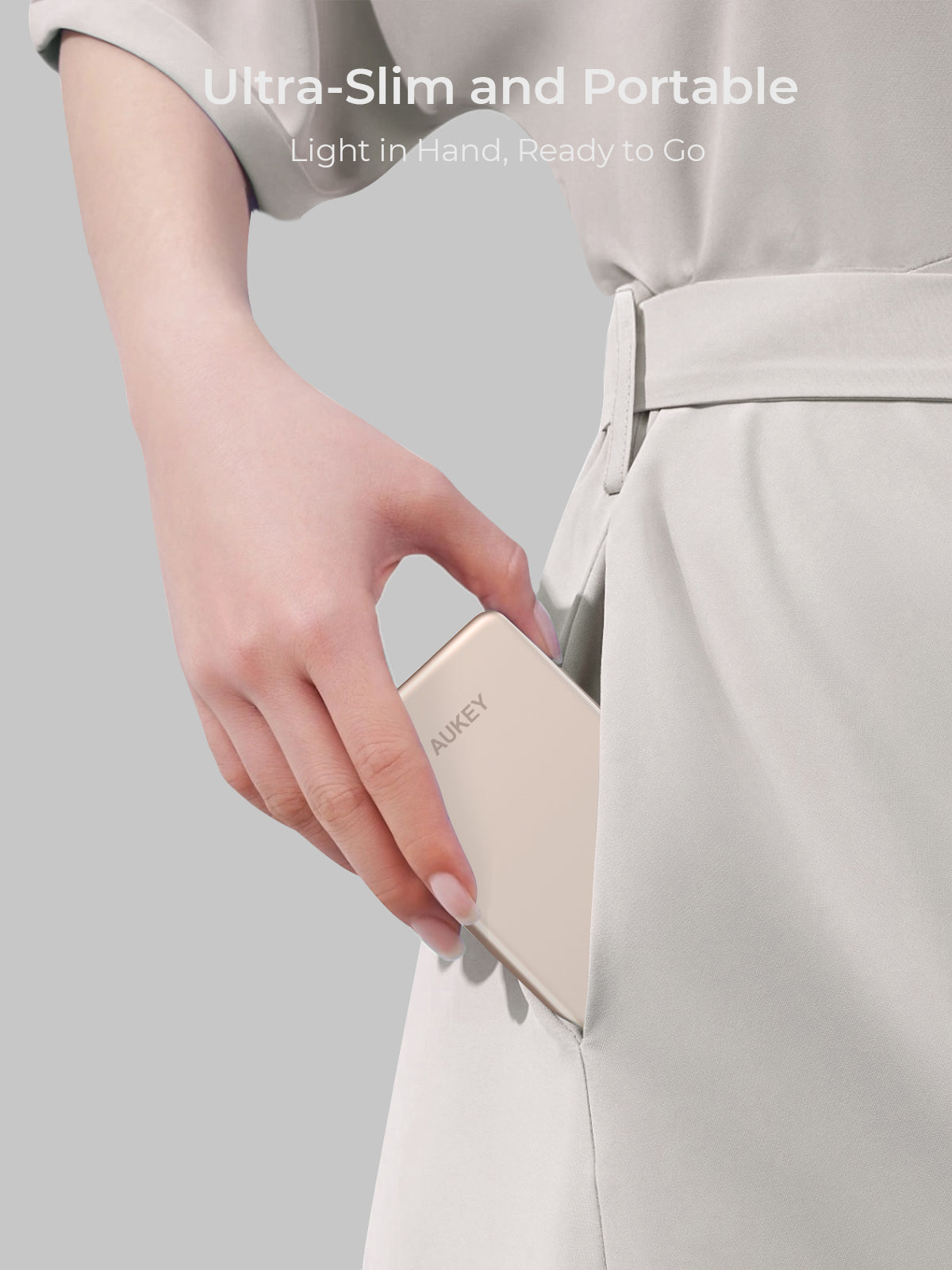 AUKEY MagFusion M 5000 20W ultra-slim portable power bank being placed in pocket
