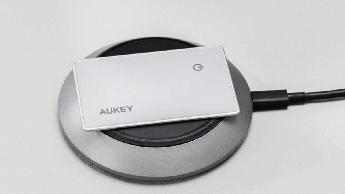 AUKEY TM-21 Track Mate 3 Bluetooth Tracker on wireless charging pad